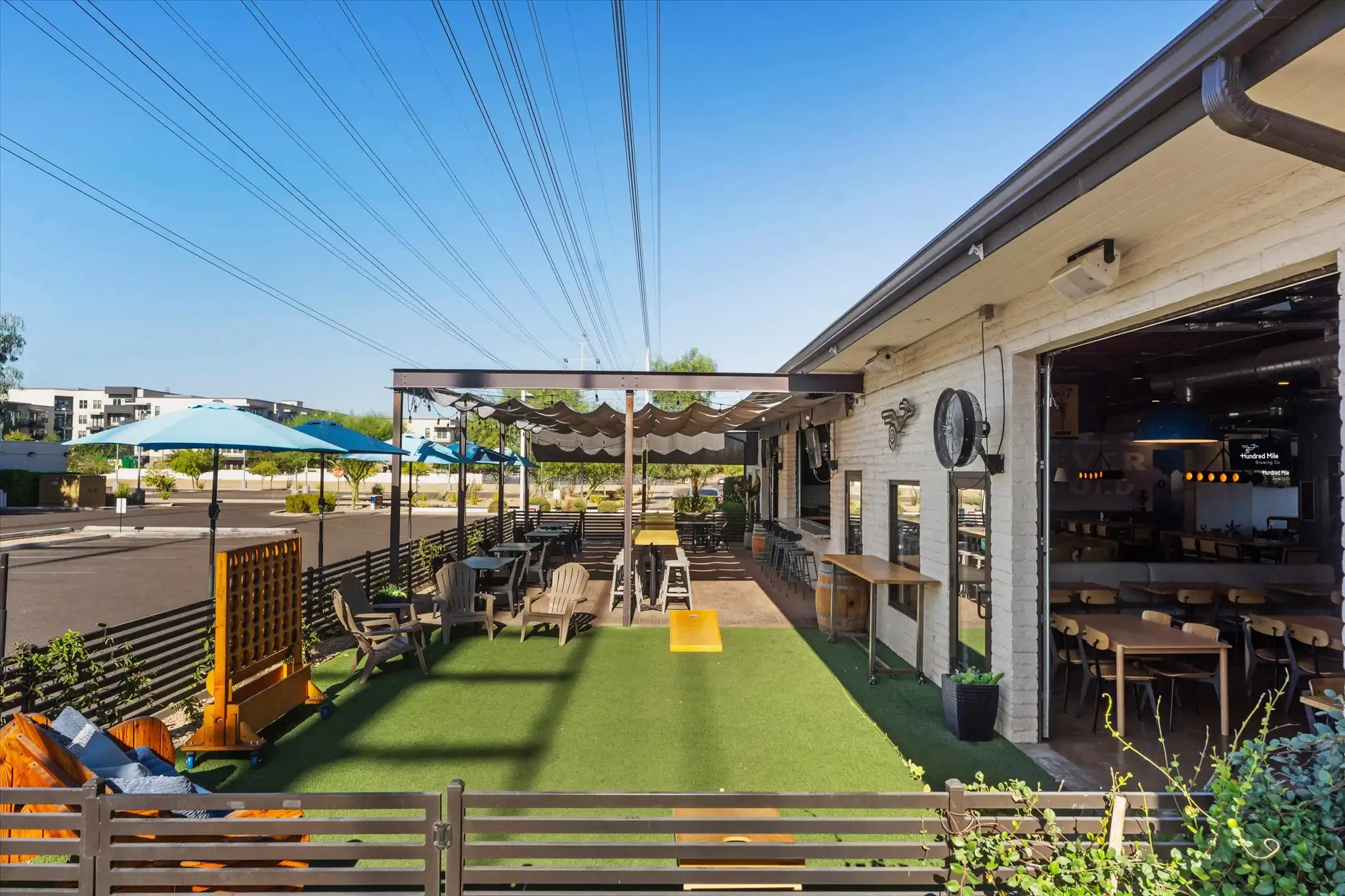 Exterior of Hundred Mile Brewing and the lawn-game patio.