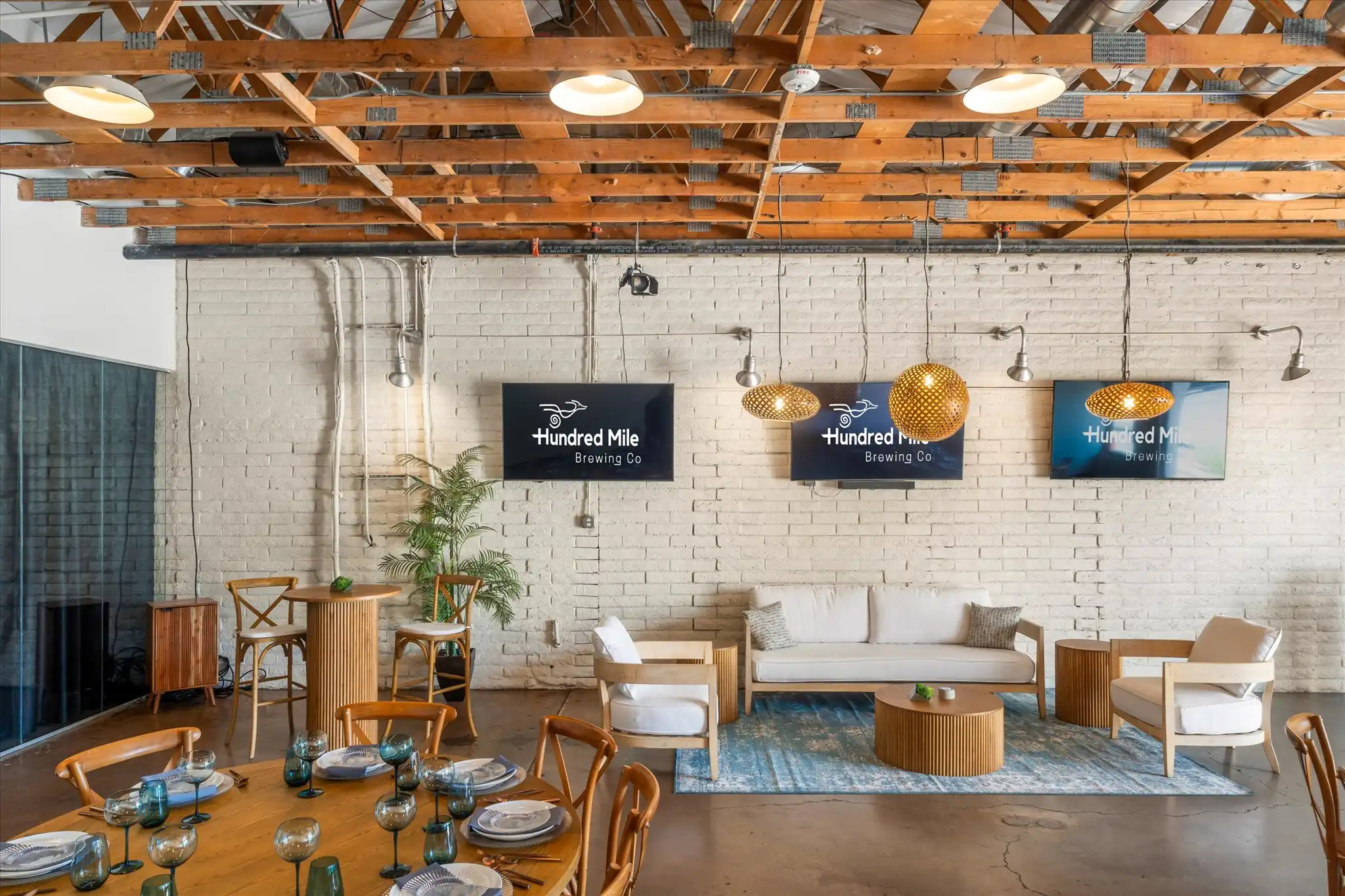 Roadrunner Room, a private event space with white brick walls and an exposed ceiling.